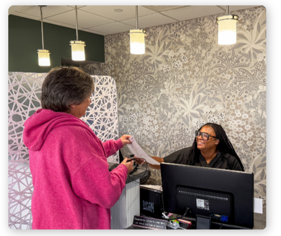 patient handing in paperwork